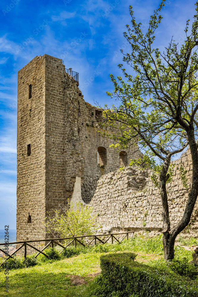 A glimpse of the ancient medieval village of Montefiascone, Viterbo, Italy. A detail of the medieval fortress of the Rocca dei Papi, which dominates the city. The imposing stone and brick building. A glimpse of the ancient medieval village of Montefiascone, Viterbo, Italy. A detail of the medieval fortress of the Rocca dei Papi, which dominates the city. The imposing stone and brick building.
