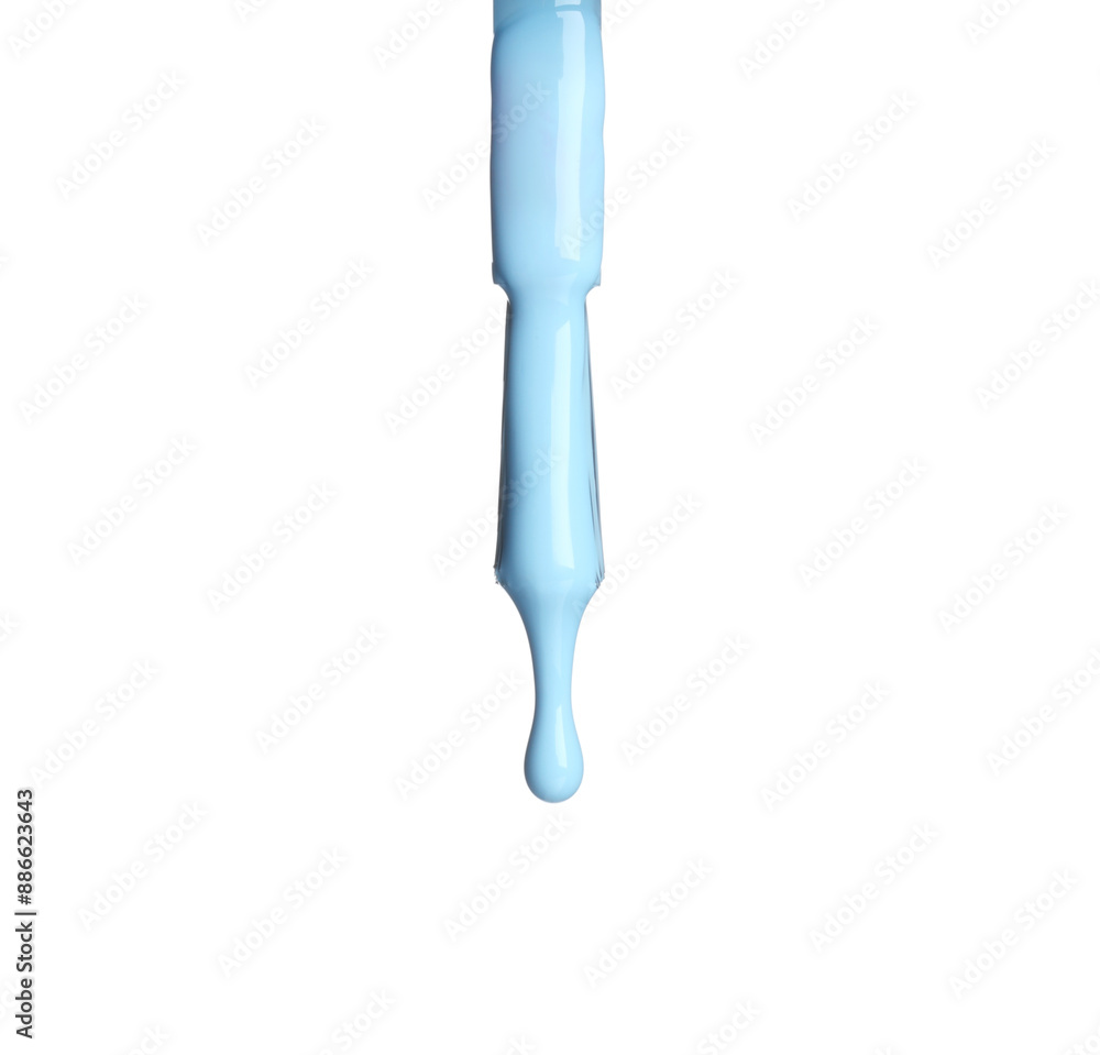 Light blue nail polish dripping from brush isolated on white Light blue nail polish dripping from brush isolated on white