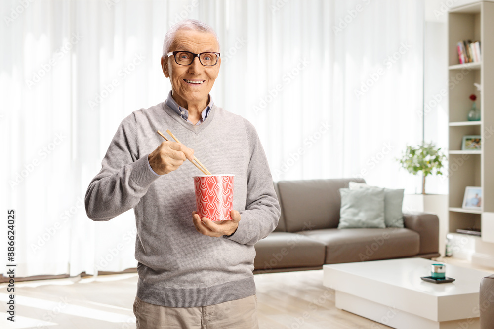 Elderly man holding a box and eating noodles Elderly man holding a box and eating noodles