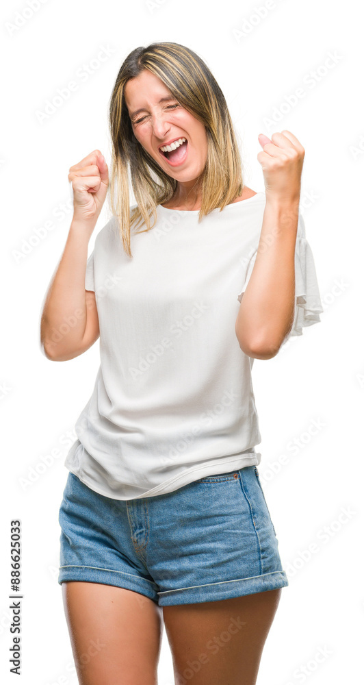 Young beautiful woman over isolated background very happy and excited doing winner gesture with arms raised, smiling and screaming for success. Celebration concept. Young beautiful woman over isolated background very happy and excited doing winner gesture with arms raised, smiling and screaming for success. Celebration concept.