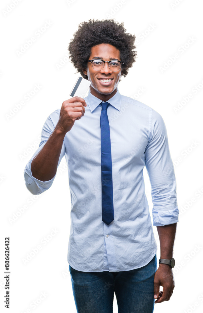 Afro american man holding credit card over isolated background with a happy face standing and smiling with a confident smile showing teeth Afro american man holding credit card over isolated background with a happy face standing and smiling with a confident smile showing teeth