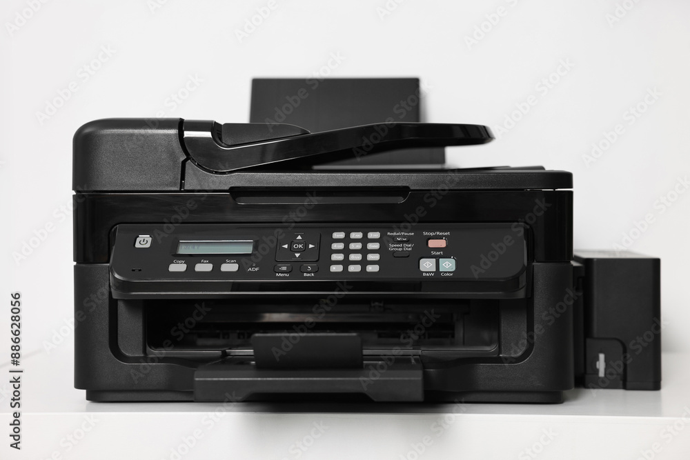 Modern printer on white table in office Modern printer on white table in office
