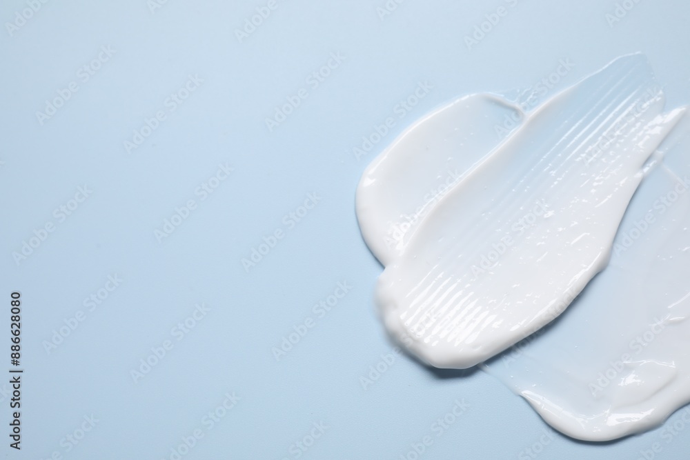 Face cream on light blue background, top view. Space for text Face cream on light blue background, top view. Space for text