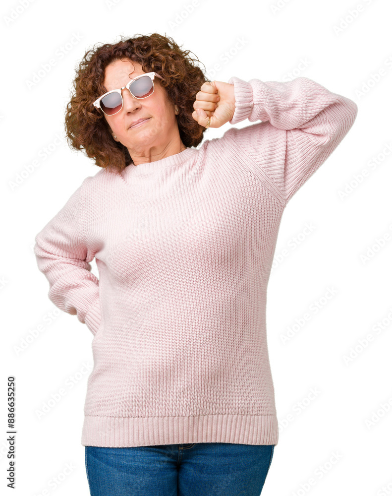 Beautiful middle ager senior woman wearing pink sweater and sunglasses over isolated background stretching back, tired and relaxed, sleepy and yawning for early morning Beautiful middle ager senior woman wearing pink sweater and sunglasses over isolated background stretching back, tired and relaxed, sleepy and yawning for early morning