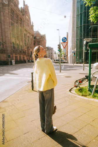 Portrait of young attractive woman fashion model posing outdoor at city street .