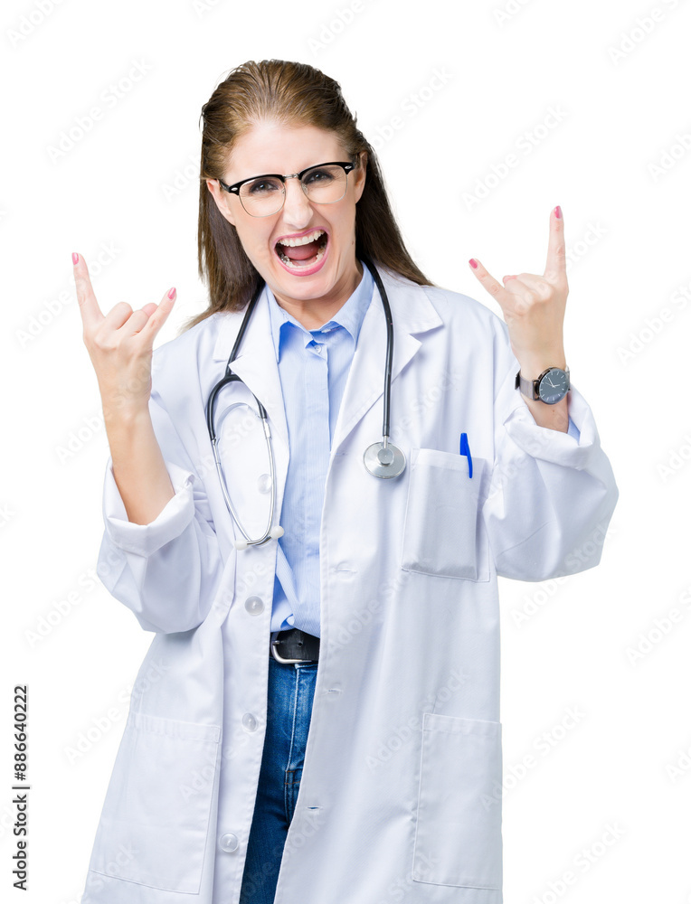 Middle age mature doctor woman wearing medical coat over isolated background shouting with crazy expression doing rock symbol with hands up. Music star. Heavy concept. Middle age mature doctor woman wearing medical coat over isolated background shouting with crazy expression doing rock symbol with hands up. Music star. Heavy concept.