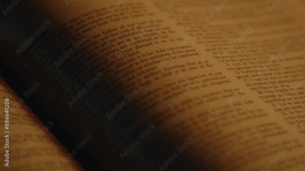 Bible printed text in soft candle light, one page of holy scripture, New Testament, Close up, High quality 4k footage Bible printed text in soft candle light, one page of holy scripture, New Testament, Close up, High quality 4k footage