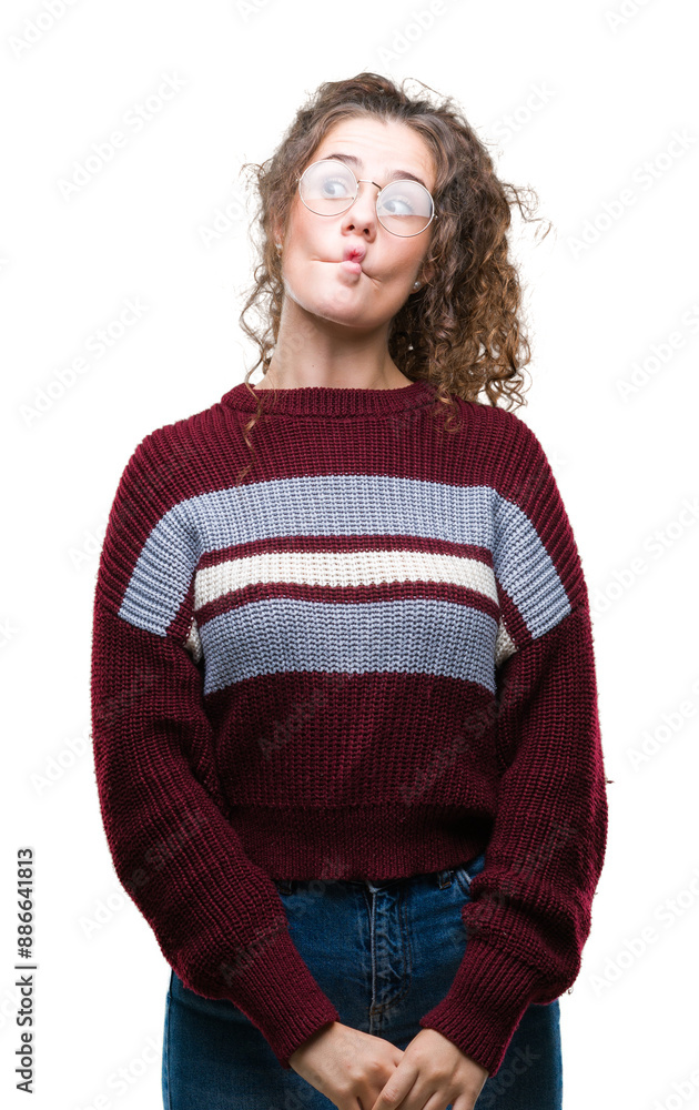 Beautiful brunette curly hair young girl wearing glasses over isolated background making fish face with lips, crazy and comical gesture. Funny expression. Beautiful brunette curly hair young girl wearing glasses over isolated background making fish face with lips, crazy and comical gesture. Funny expression.