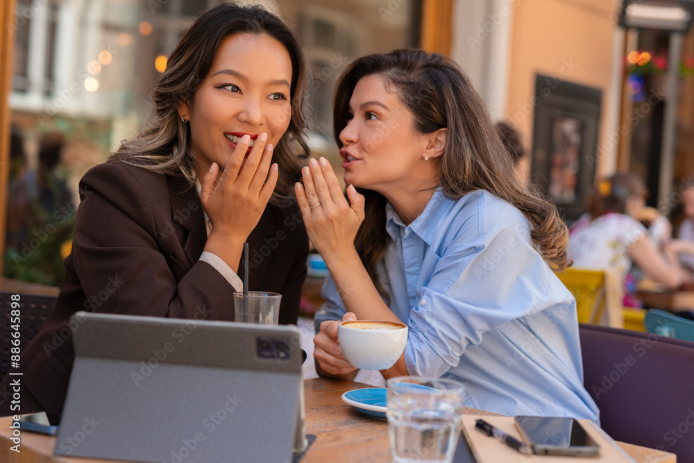Two woman sitting in coffee shop and gossip Two woman sitting in coffee shop and gossip