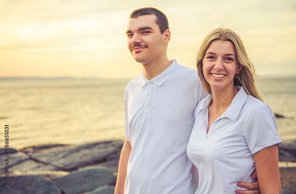 brother and sister having great time at the beach on sunset time brother and sister having great time at the beach on sunset time