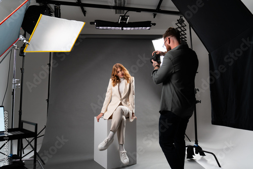 Tableau sur toile Studio photoshoot with model and photographer for artistic, commercial, or edito