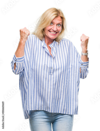 Middle age blonde business woman over isolated background very happy and excited doing winner gesture with arms raised, smiling and screaming for success. Celebration concept.