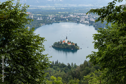 Panoramic view from Lake Bled, beauty heritage in Slovenia. Island with church and castle in the background create a dream setting. View from Ojstrica and Mala Osojnica with the heart-shaped bench. photo