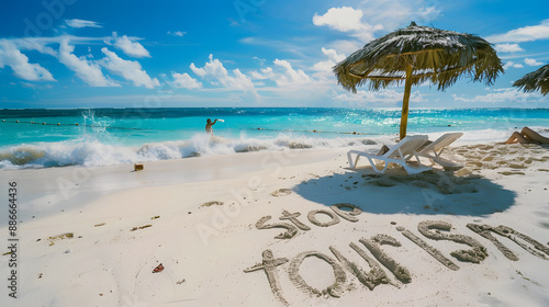 Stop tourism anti tourism message written in the sand on a beach. 