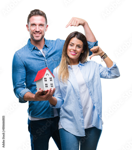 Konstfotografi Young couple in love holding house over isolated background with surprise face p