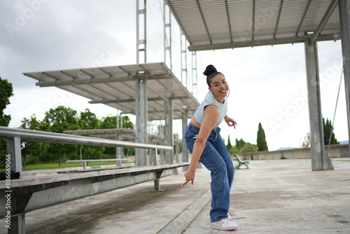 A woman is dancing on a concrete floor