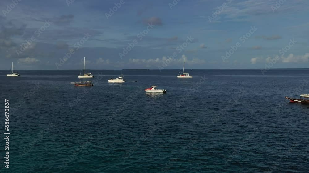 Tranquil Morning Sailboats Drifting in the Caribbean Sea. A serene scene of sailboats calmly floating in the crystal clear waters of the Caribbean Sea. The sun shines brightly overhead. Tranquil Morning Sailboats Drifting in the Caribbean Sea. A serene scene of sailboats calmly floating in the crystal clear waters of the Caribbean Sea. The sun shines brightly overhead.