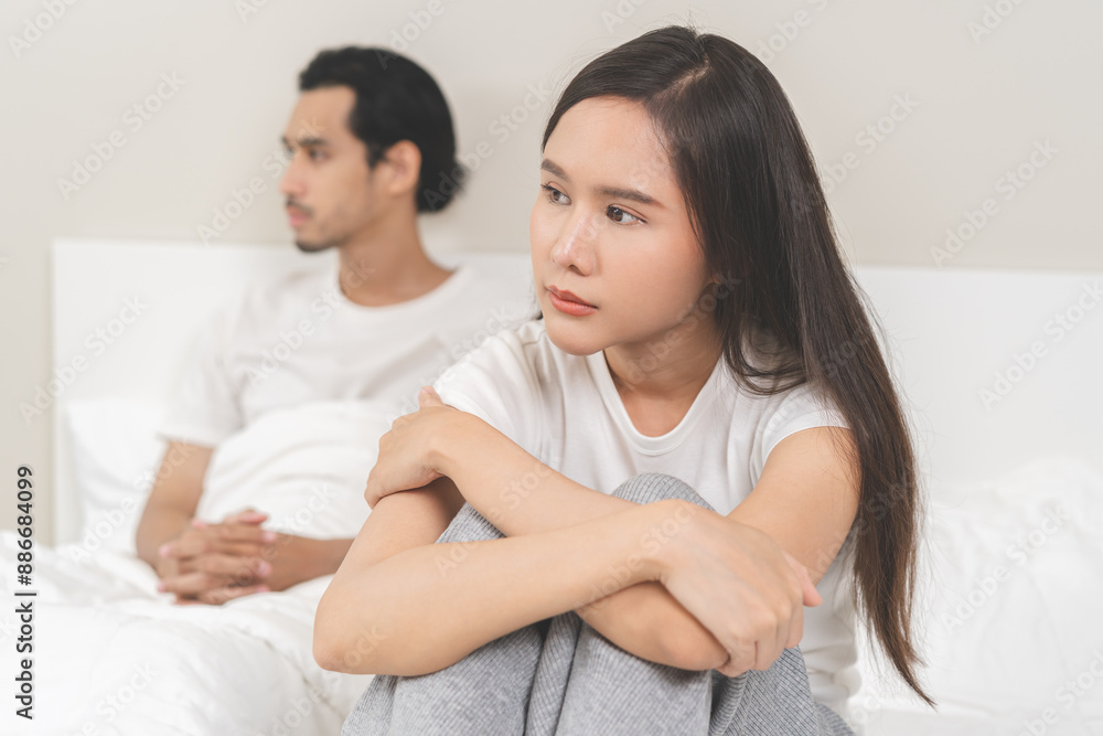 Angry, depressed, frustrated asian couple quarrel, fighting on bed in conflict, divorce or relationship problem, stress from marriage, fight and argument, unhappy married couple and sexual impotent. Angry, depressed, frustrated asian couple quarrel, fighting on bed in conflict, divorce or relationship problem, stress from marriage, fight and argument, unhappy married couple and sexual impotent.