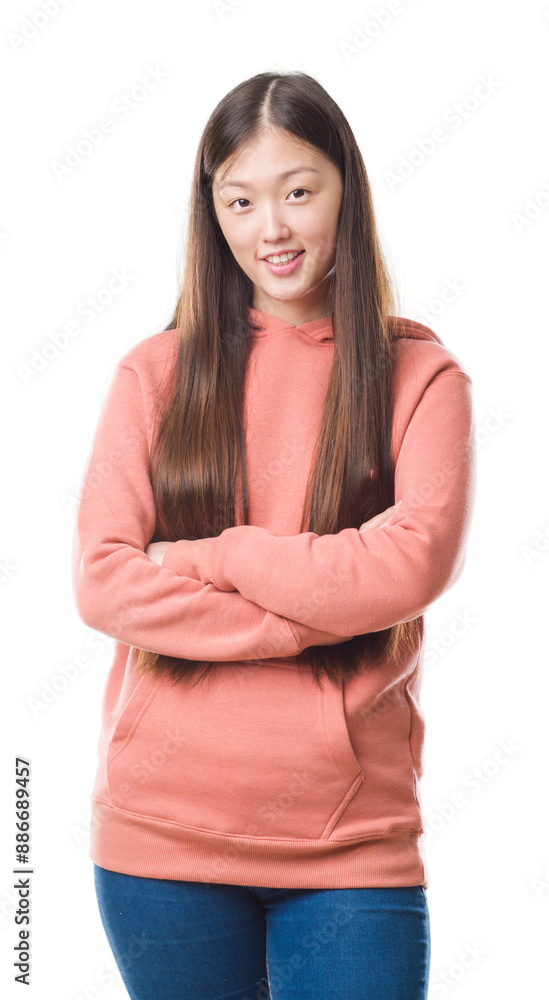 Young Chinese woman over isolated background wearing sport sweathshirt happy face smiling with crossed arms looking at the camera. Positive person. Young Chinese woman over isolated background wearing sport sweathshirt happy face smiling with crossed arms looking at the camera. Positive person.