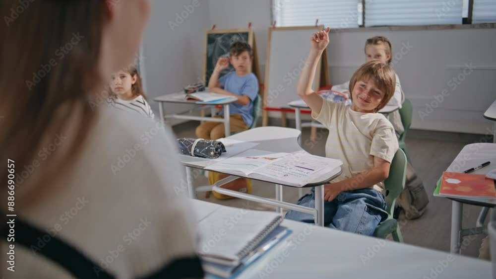 Smart kids raising hands at lesson. Teacher talking pupils explaining at school Smart kids raising hands at lesson. Teacher talking pupils explaining at school