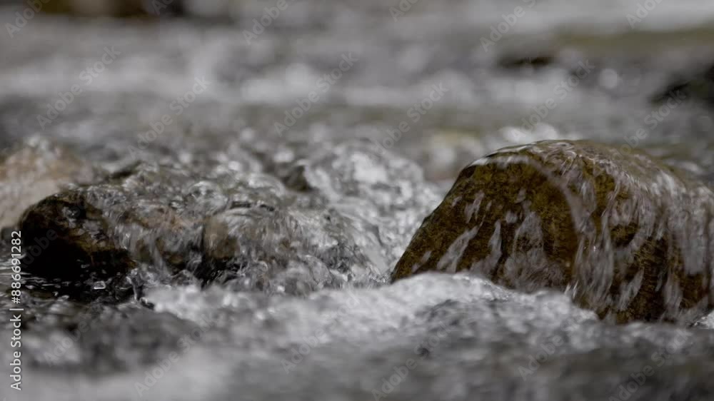 4k slow motion video of running water over a stream rock with great texture. 4k slow motion video of running water over a stream rock with great texture.