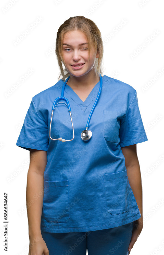 Young caucasian doctor woman wearing surgeon uniform over isolated background winking looking at the camera with sexy expression, cheerful and happy face. Young caucasian doctor woman wearing surgeon uniform over isolated background winking looking at the camera with sexy expression, cheerful and happy face.