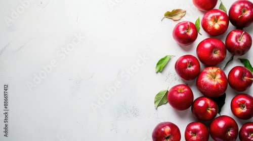 Red apples on white table with space for text