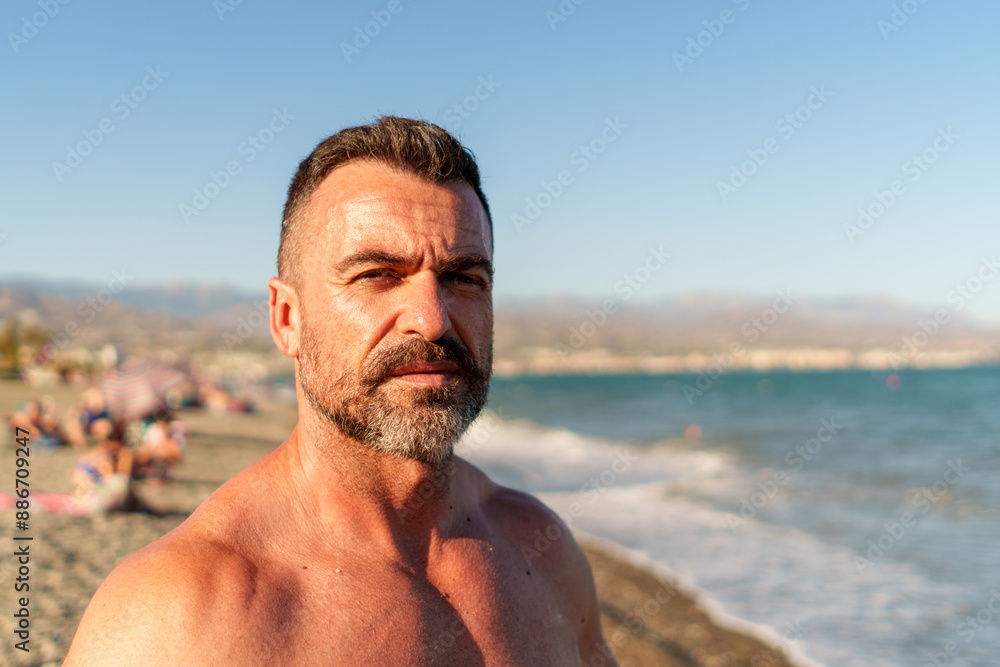 Middle-aged man taking a selfie on the beach with blurred background and copy space Middle-aged man taking a selfie on the beach with blurred background and copy space