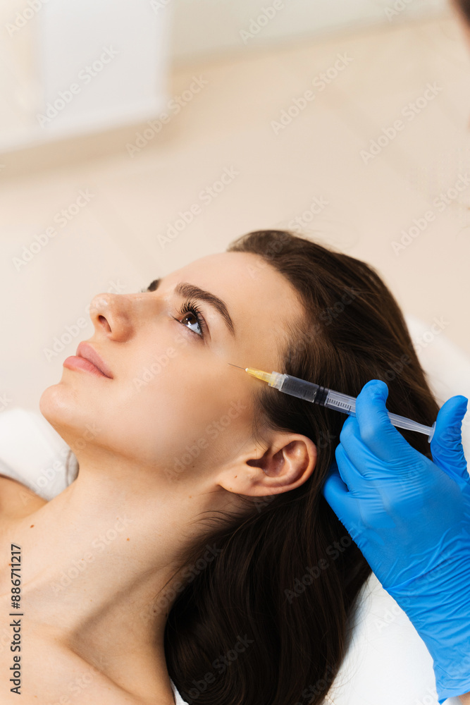 Cosmetology injections for getting rid of wrinkles. Young caucasian girl improves skin condition in cosmetology clinic. Cosmetology injections for getting rid of wrinkles. Young caucasian girl improves skin condition in cosmetology clinic.