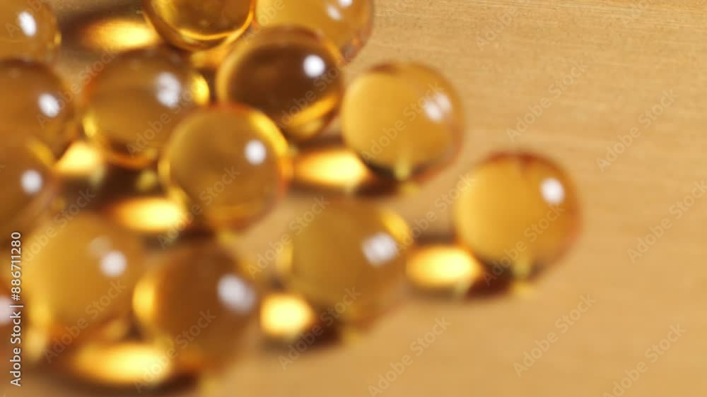 Close-up of yellow omega 3 gel capsule,Fish oil supplement,vitamin E,Concept of Healthy Living,4k footage Close-up of yellow omega 3 gel capsule,Fish oil supplement,vitamin E,Concept of Healthy Living,4k footage