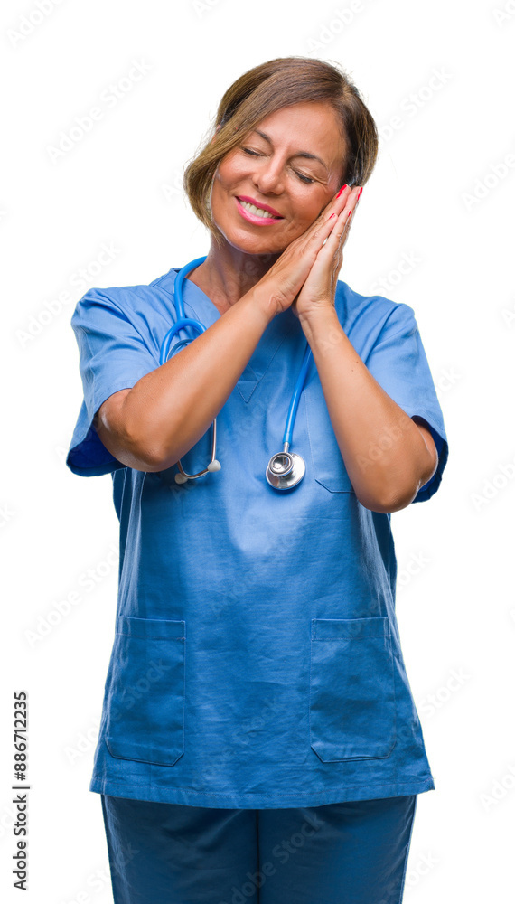 Middle age senior nurse doctor woman over isolated background sleeping tired dreaming and posing with hands together while smiling with closed eyes. Middle age senior nurse doctor woman over isolated background sleeping tired dreaming and posing with hands together while smiling with closed eyes.