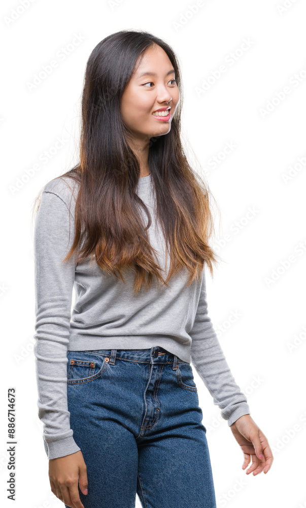 Young asian woman over isolated background looking away to side with smile on face, natural expression. Laughing confident. Young asian woman over isolated background looking away to side with smile on face, natural expression. Laughing confident.