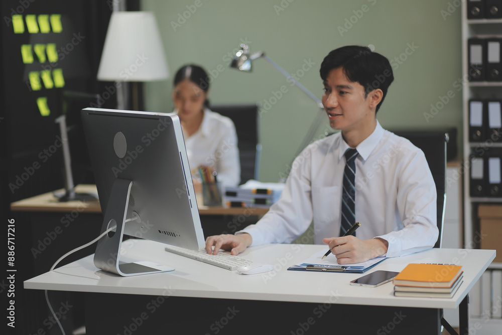 Modern Office Businessman Working on Computer. Portrait of Successful Latin IT Software Engineer Working on a Laptop at his Desk. Diverse Workplace with Professionals. Front View Shot