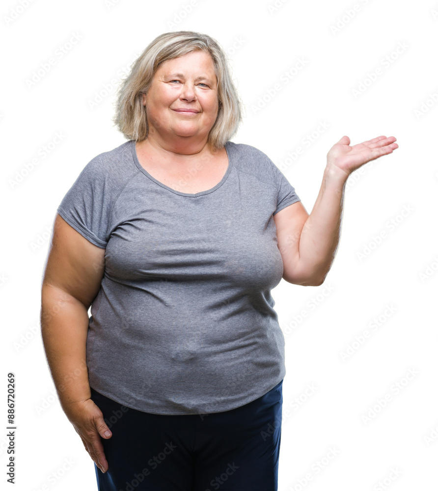 Senior plus size caucasian woman over isolated background smiling cheerful presenting and pointing with palm of hand looking at the camera. Senior plus size caucasian woman over isolated background smiling cheerful presenting and pointing with palm of hand looking at the camera.