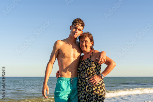 Photos Hispanic woman in her 70s on the beach with her grandson, about 17 years old