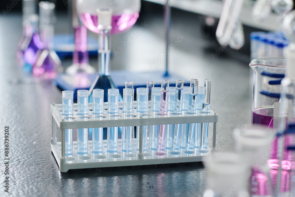 Group of flasks containing blue liquid substances standing in front of camera on workplace of chemist ready for new experiment Group of flasks containing blue liquid substances standing in front of camera on workplace of chemist ready for new experiment