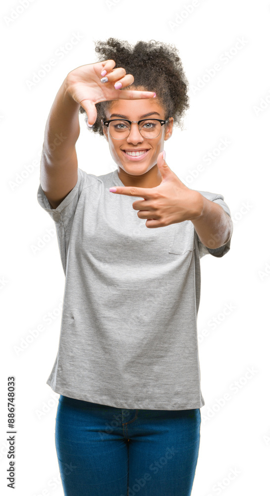 Young afro american woman wearing glasses over isolated background smiling making frame with hands and fingers with happy face. Creativity and photography concept. Young afro american woman wearing glasses over isolated background smiling making frame with hands and fingers with happy face. Creativity and photography concept.