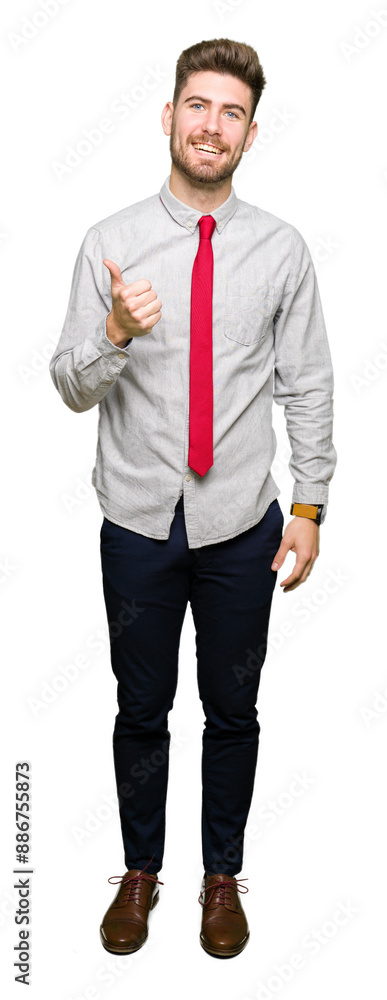 Young handsome business man doing happy thumbs up gesture with hand. Approving expression looking at the camera showing success. Young handsome business man doing happy thumbs up gesture with hand. Approving expression looking at the camera showing success.