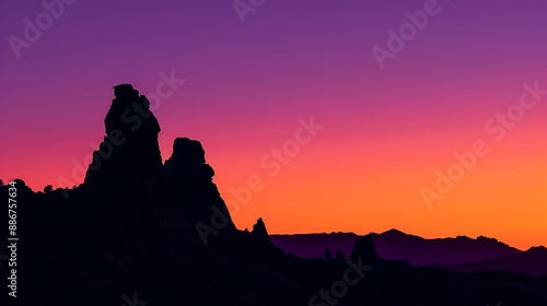 Church Rock at twilight, silhouetted against a gradient sky transitioning from orange to deep purple.