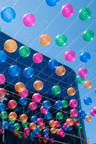 People walk along the shopping street called Meritxell decorated with colorful balls in the capital Andorra la Vella, Andorra in 2024.