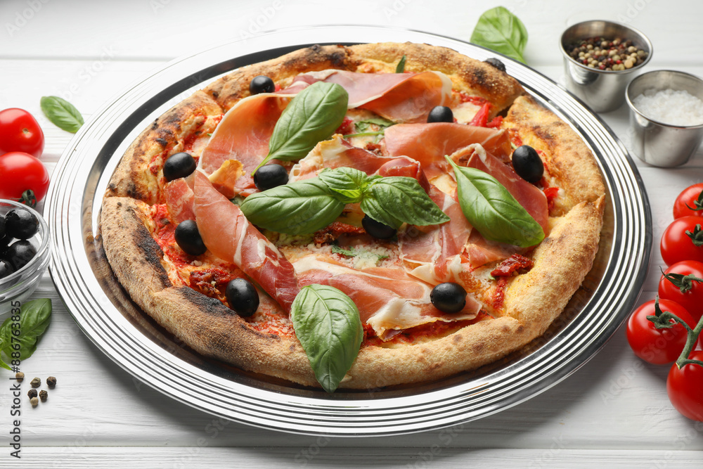 Tasty pizza with cured ham, olives, tomatoes and basil on white wooden table, closeup Tasty pizza with cured ham, olives, tomatoes and basil on white wooden table, closeup