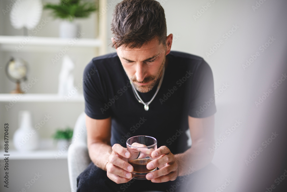 alone depressed male drink booze on sofa at home. Treatment of alcohol addiction, suffer abuse problem alcoholism. alone depressed male drink booze on sofa at home. Treatment of alcohol addiction, suffer abuse problem alcoholism.