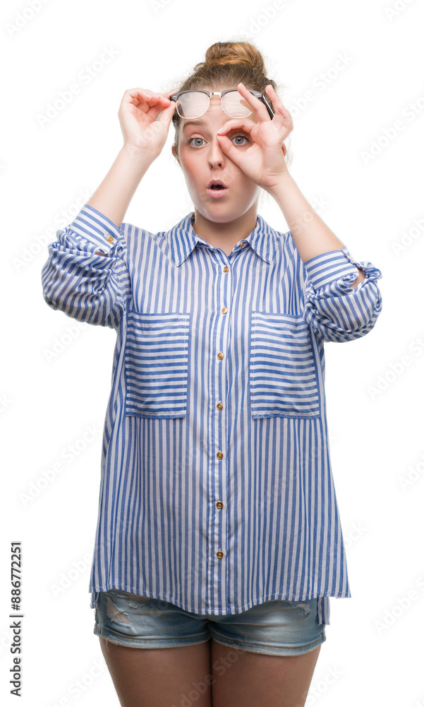 Young blonde business woman doing ok gesture shocked with surprised face, eye looking through fingers. Unbelieving expression. Young blonde business woman doing ok gesture shocked with surprised face, eye looking through fingers. Unbelieving expression.