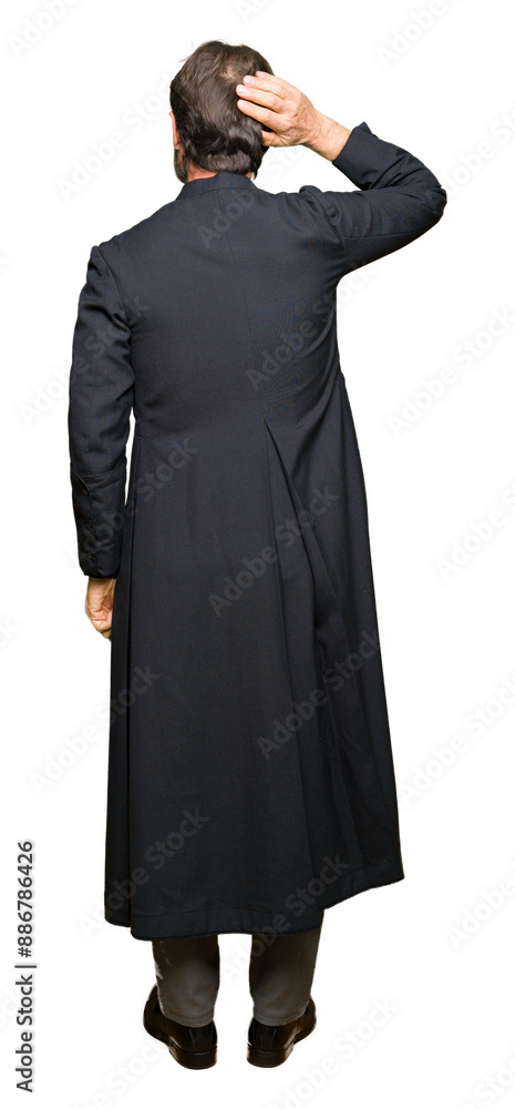 Middle age priest man wearing catholic robe Backwards thinking about doubt with hand on head Middle age priest man wearing catholic robe Backwards thinking about doubt with hand on head