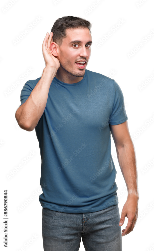 Handsome young casual man smiling with hand over ear listening an hearing to rumor or gossip. Deafness concept. Handsome young casual man smiling with hand over ear listening an hearing to rumor or gossip. Deafness concept.