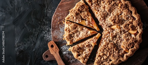 Top view of apple crumble pie slices on a wooden board with ample copy space image. photo