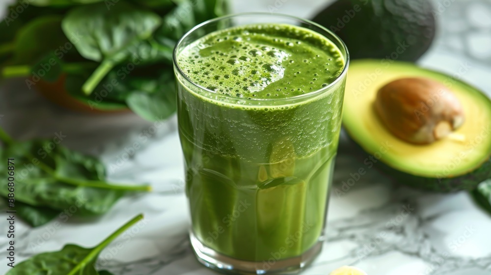a glass of green smoothie made with spinach, avocado, and banana, displayed on a marble table as a concept for medical food a glass of green smoothie made with spinach, avocado, and banana, displayed on a marble table as a concept for medical food
