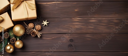 Homemade Christmas and New Year gift boxes with decorations on wooden background for festive holiday concepts. Top view with empty space for text or image.