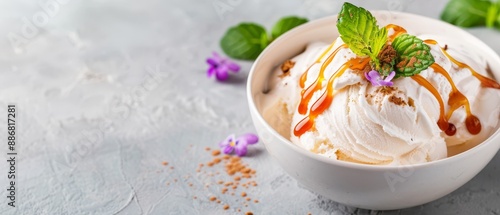  A white bowl holds scoops of ice cream, garnished with fresh mint and a sprig for an aromatic touch