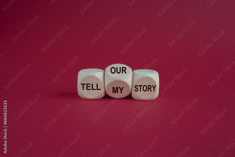 Tell my or our story. Turned a wooden cube and changed words tell my story to tell our story. Beautiful pink background. Business, storytelling and my or our story concept.